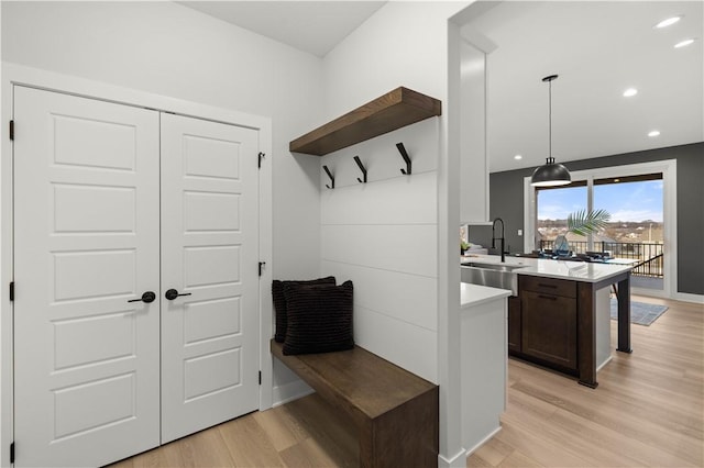 mudroom featuring light wood-type flooring and sink