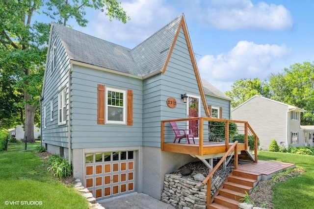 exterior space featuring a lawn, a garage, and a deck