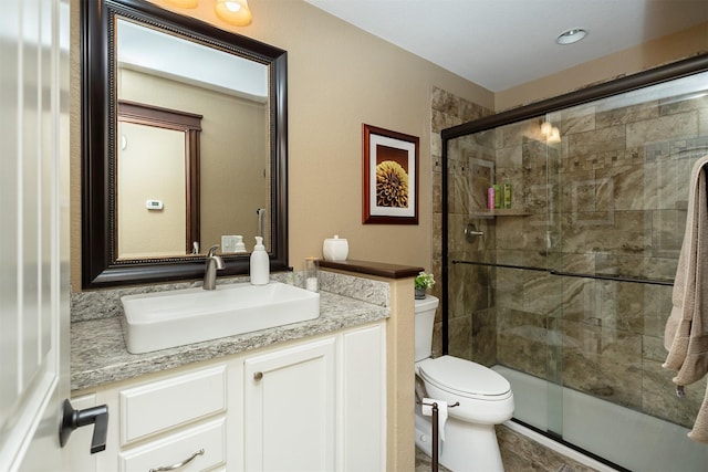 bathroom with vanity, toilet, and walk in shower