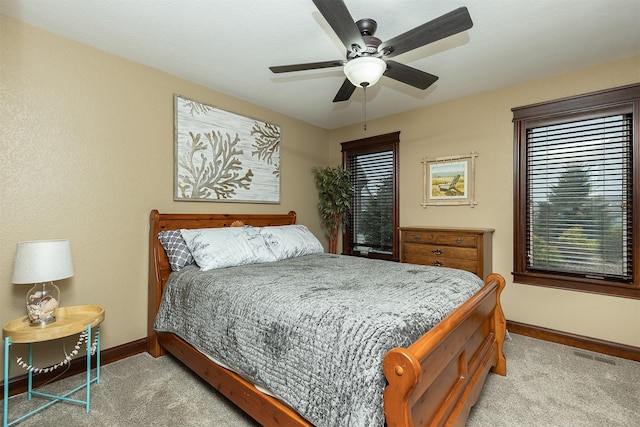 bedroom featuring ceiling fan and light carpet