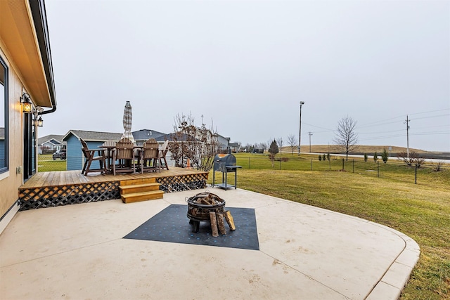 view of patio with an outdoor fire pit and a wooden deck