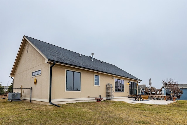 rear view of property featuring central AC, a yard, and a patio