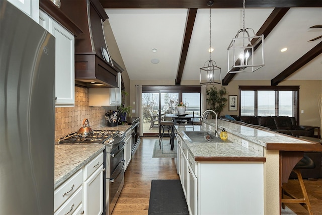 kitchen featuring white cabinetry, hanging light fixtures, a notable chandelier, and appliances with stainless steel finishes