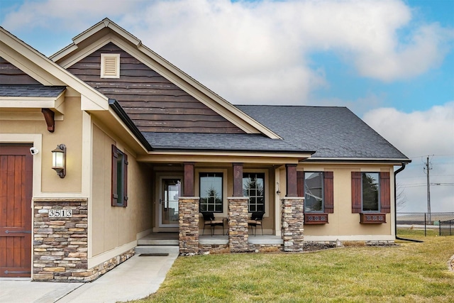 3513 Sunstone Ct SE, Altoona, IA 50009 - view of front facade featuring covered porch, a shingled roof, and stone siding