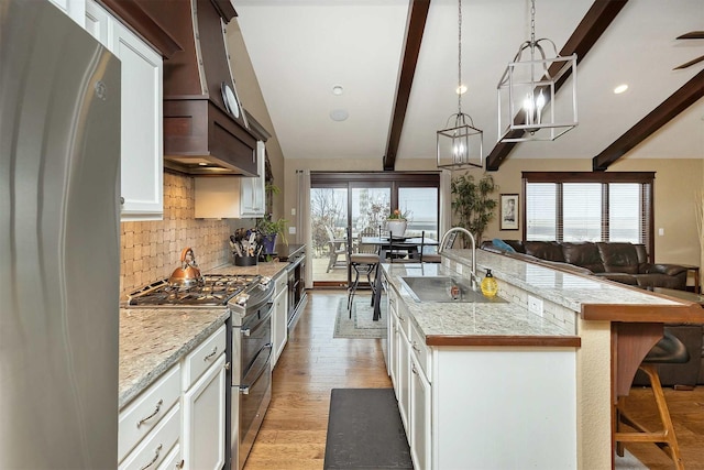 3513 Sunstone Ct SE, Altoona, IA 50009 - kitchen featuring stainless steel appliances, backsplash, a spacious island, open floor plan, and plenty of natural light