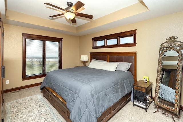 3513 Sunstone Ct SE, Altoona, IA 50009 - bedroom featuring light colored carpet, a tray ceiling, and a ceiling fan