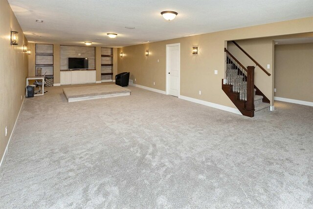 3513 Sunstone Ct SE, Altoona, IA 50009 - unfurnished living room featuring stairs, carpet, and a textured ceiling