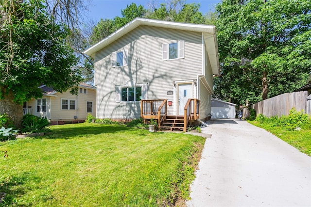 view of front of home with a garage, an outbuilding, a front lawn, and a deck