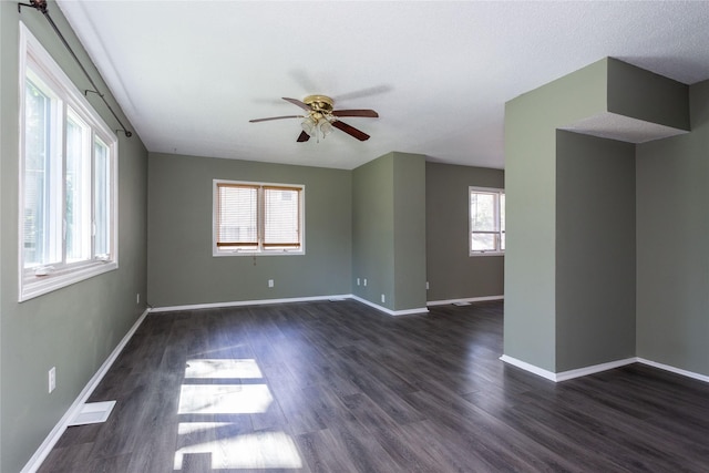 unfurnished room with dark hardwood / wood-style floors, a textured ceiling, and ceiling fan