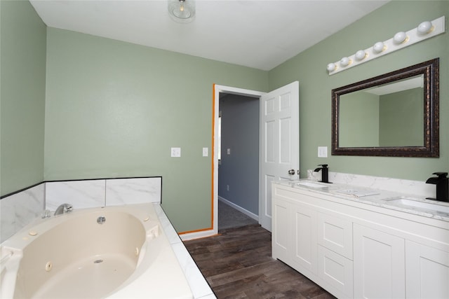 bathroom featuring wood-type flooring, a bath, and vanity