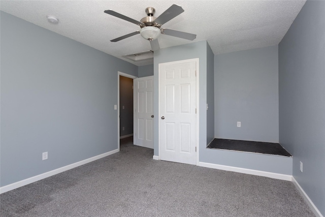 unfurnished bedroom with ceiling fan, carpet, and a textured ceiling