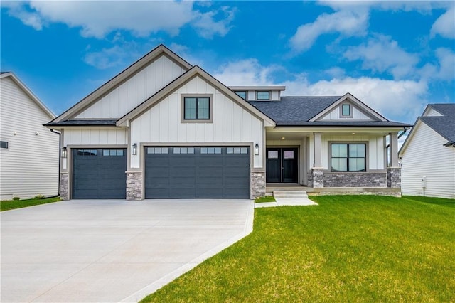 view of front of property featuring stone siding, driveway, board and batten siding, and a front yard