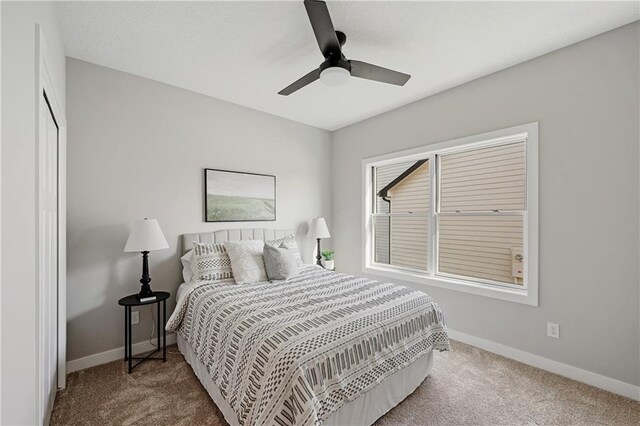 carpeted bedroom featuring ceiling fan