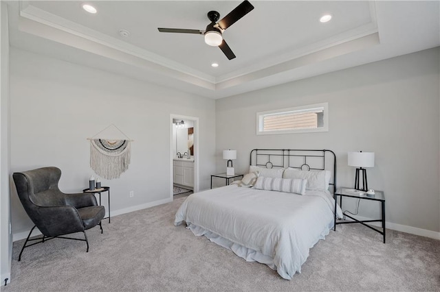 carpeted bedroom featuring recessed lighting, baseboards, a tray ceiling, and ornamental molding