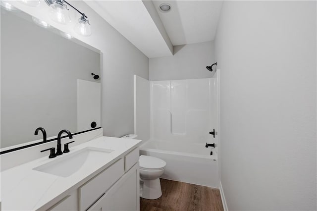 full bath with shower / bath combination, toilet, vanity, and wood finished floors