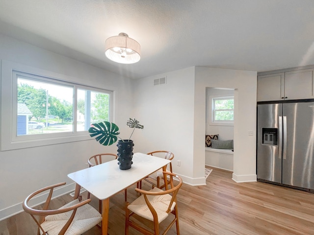 dining space featuring light wood-type flooring