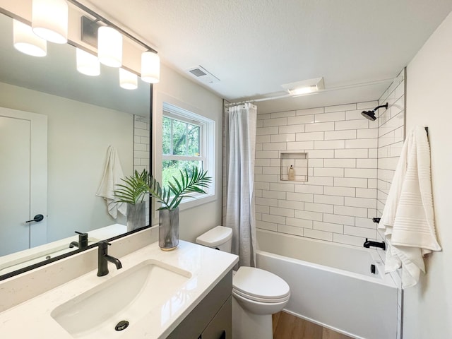 full bathroom featuring vanity, a textured ceiling, wood-type flooring, shower / bathtub combination with curtain, and toilet