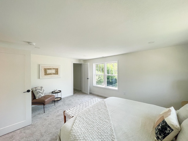 bedroom featuring light carpet