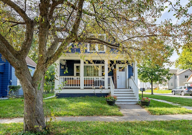 view of front of home featuring covered porch and a front yard