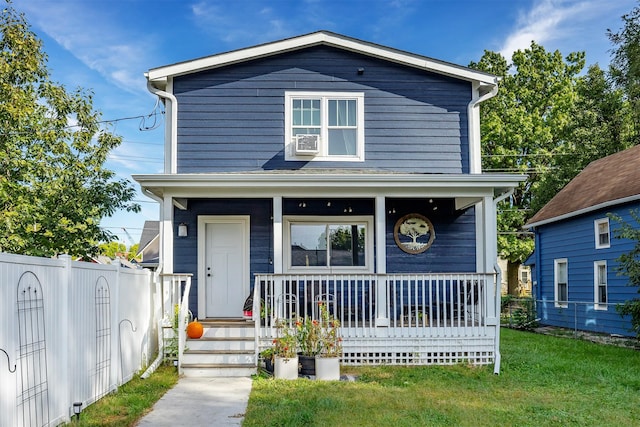 view of front of property featuring cooling unit, covered porch, and a front yard