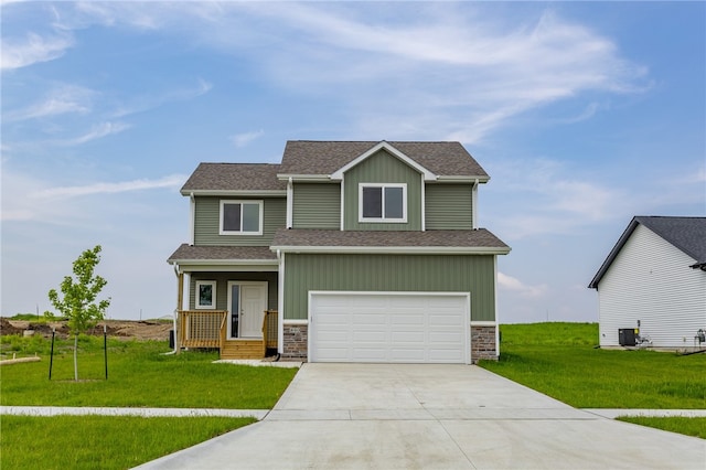 craftsman house with a front yard and a garage