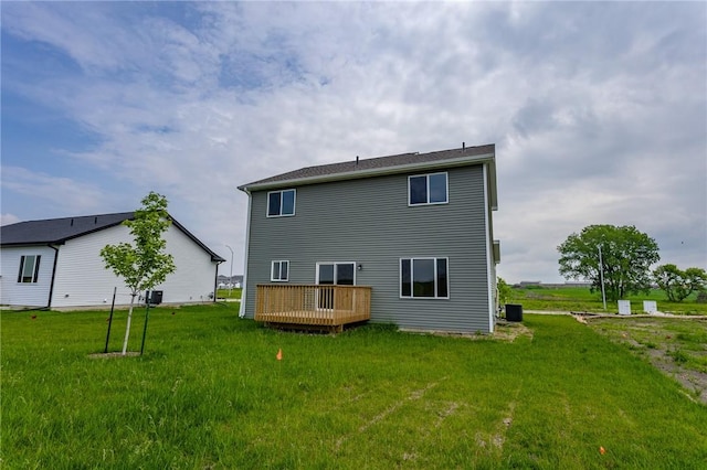 back of property featuring a lawn, cooling unit, and a wooden deck