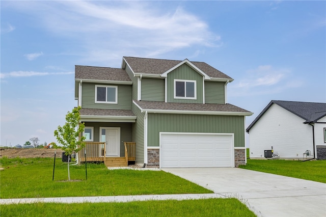 craftsman house featuring central AC, a front lawn, and a garage