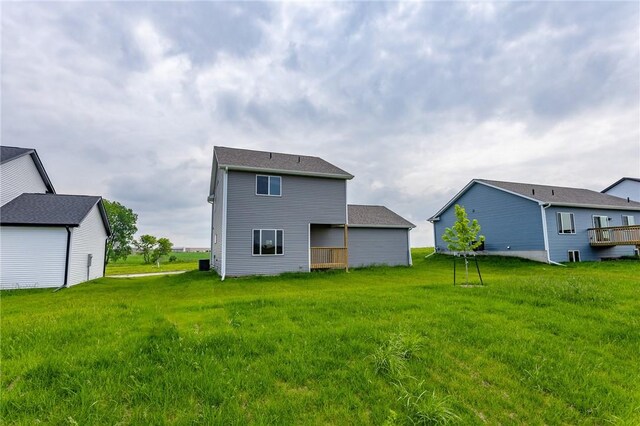 rear view of house featuring a lawn