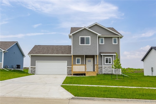 view of front of property with a front yard and a garage