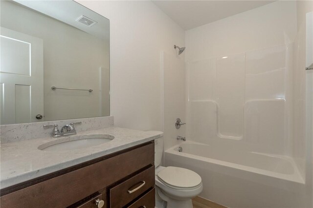 full bathroom with vanity, bathing tub / shower combination, and toilet