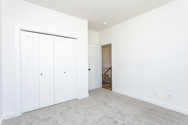 985 11th St, Waukee, IA 50263 - unfurnished bedroom featuring carpet, a closet, and baseboards
