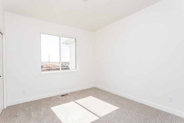 985 11th St, Waukee, IA 50263 - empty room featuring baseboards, light carpet, and visible vents