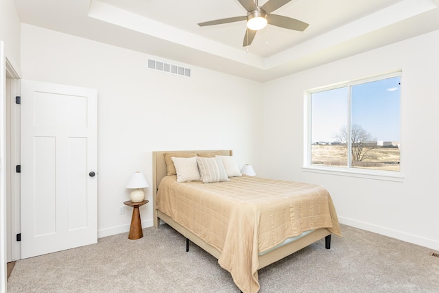 985 11th St, Waukee, IA 50263 - bedroom with baseboards, a raised ceiling, light carpet, and visible vents