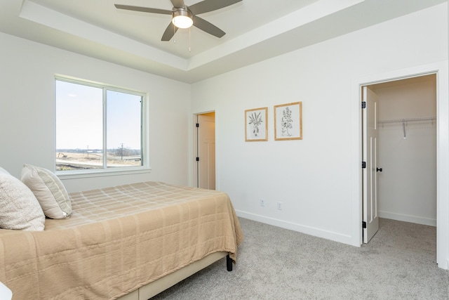 985 11th St, Waukee, IA 50263 - bedroom with carpet, a ceiling fan, a walk in closet, baseboards, and a raised ceiling