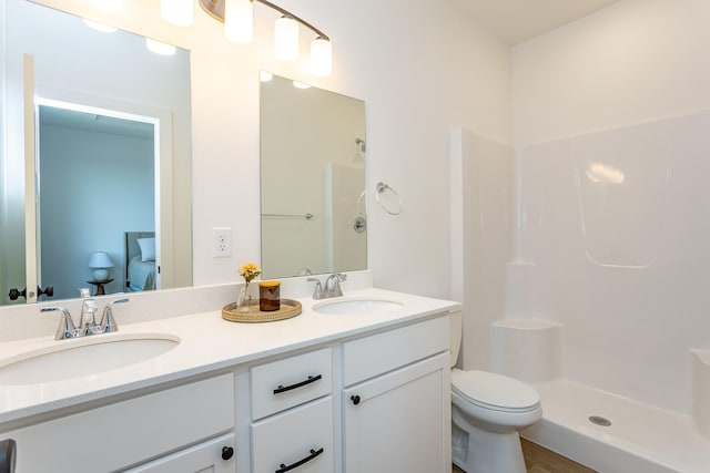 985 11th St, Waukee, IA 50263 - bathroom with toilet, walk in shower, double vanity, and a sink