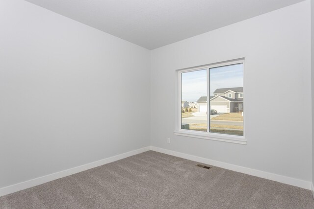 1060 Gray Ave, Waukee, IA 50263 - unfurnished room with baseboards, visible vents, and carpet