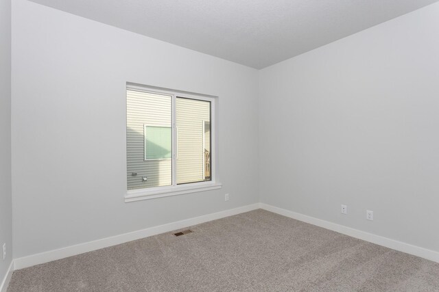1060 Gray Ave, Waukee, IA 50263 - carpeted empty room with baseboards and visible vents
