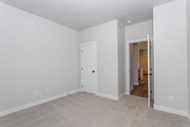 1060 Gray Ave, Waukee, IA 50263 - unfurnished bedroom featuring baseboards, visible vents, and carpet floors