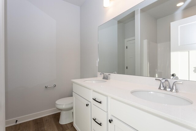 1060 Gray Ave, Waukee, IA 50263 - bathroom with toilet, a sink, baseboards, and wood finished floors