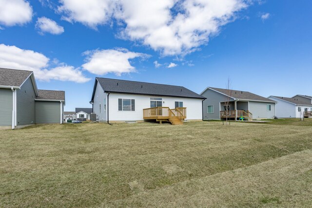 1060 Gray Ave, Waukee, IA 50263 - back of property featuring a yard, central AC unit, and a deck