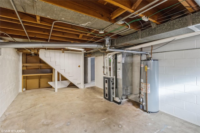 basement featuring heating unit and water heater