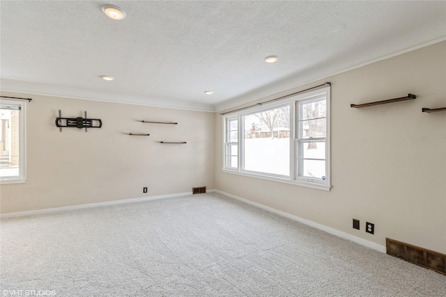 unfurnished room featuring carpet floors and a textured ceiling