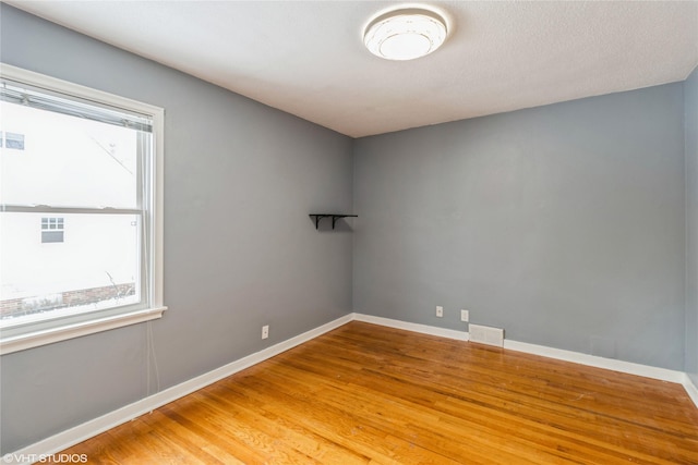 empty room with wood-type flooring