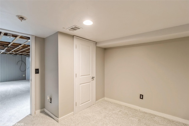 basement featuring light carpet