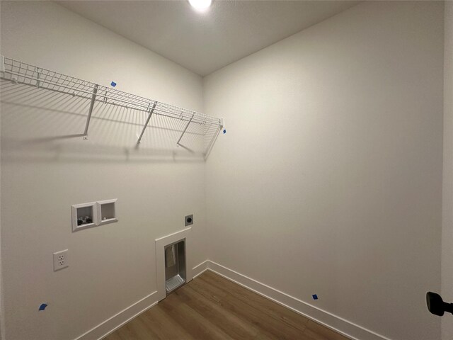 washroom featuring electric dryer hookup, dark hardwood / wood-style flooring, and washer hookup