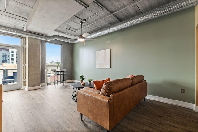 living room featuring hardwood / wood-style floors and ceiling fan