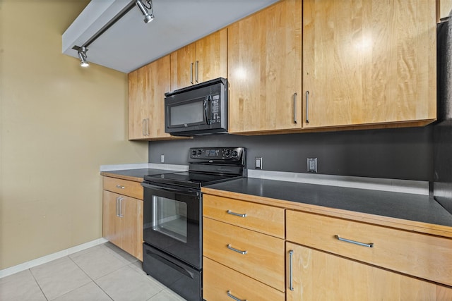 kitchen with light tile patterned flooring, black appliances, and track lighting