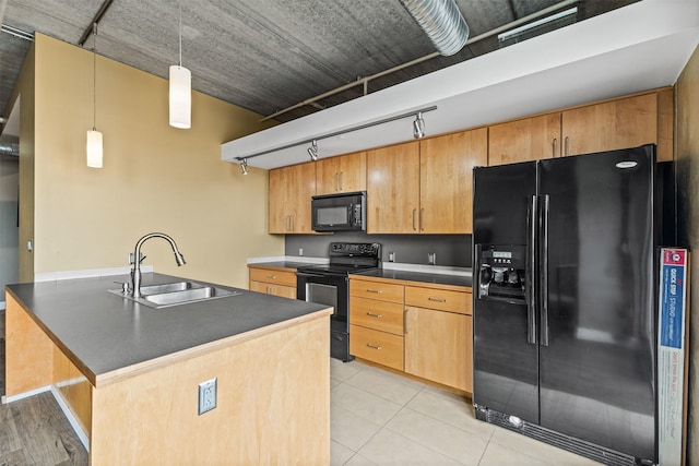 kitchen with sink, black appliances, decorative light fixtures, a center island, and light tile patterned flooring