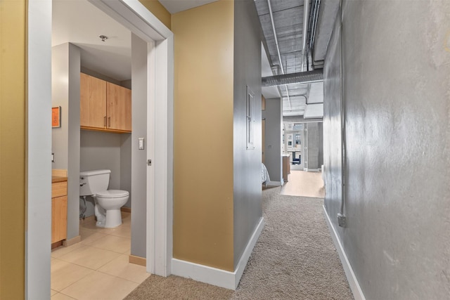 hallway featuring light colored carpet