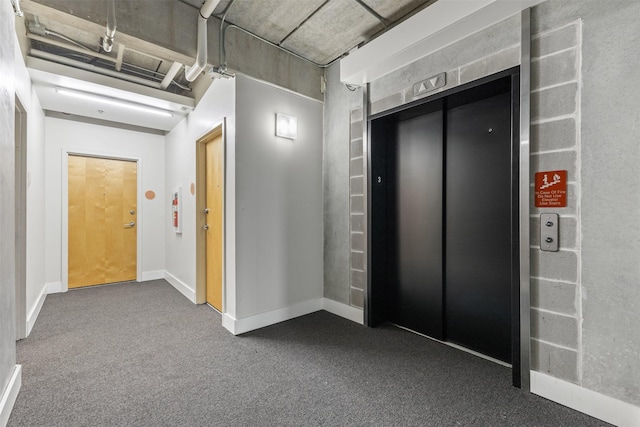 hallway featuring carpet and elevator